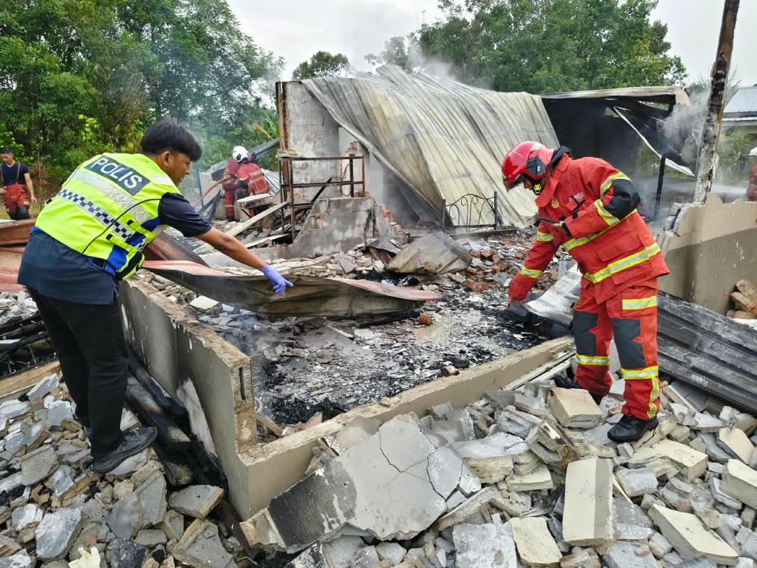 Police confirm a woman found wrapped up in a house fire in Batu Kawa